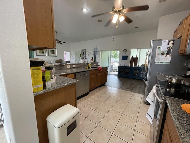 15-1765 28th Ave, Keaau, HI 96749 - kitchen featuring appliances with stainless steel finishes, ceiling fan, light tile patterned floors, brown cabinets, and dark stone countertops