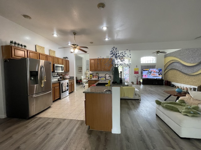 15-1765 28th Ave, Keaau, HI 96749 - kitchen with appliances with stainless steel finishes, ceiling fan, open floor plan, and dark countertops