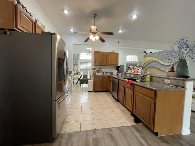 15-1765 28th Ave, Keaau, HI 96749 - kitchen featuring appliances with stainless steel finishes, a ceiling fan, a peninsula, a sink, and brown cabinetry