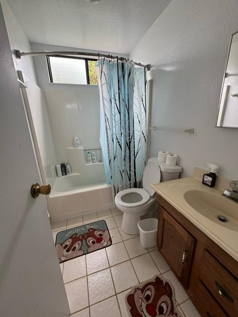 17-7860 Kulani Rd, Mountain View, HI 96771 - bathroom with tile patterned floors, shower / bathtub combination with curtain, vanity, toilet, and a textured ceiling
