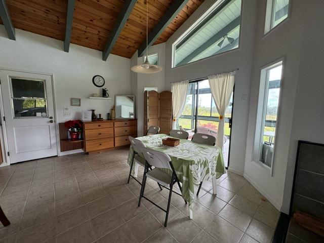 17-7860 Kulani Rd, Mountain View, HI 96771 - tiled dining area featuring wooden ceiling with exposed beams, high vaulted ceiling, and baseboards