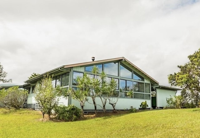 17-7860 Kulani Rd, Mountain View, HI 96771 - rear view of property with a sunroom and a yard