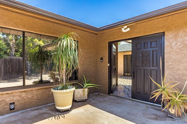 68-3753 Piki Pl, Waikoloa, HI 96738 - view of exterior entry featuring stucco siding and a patio