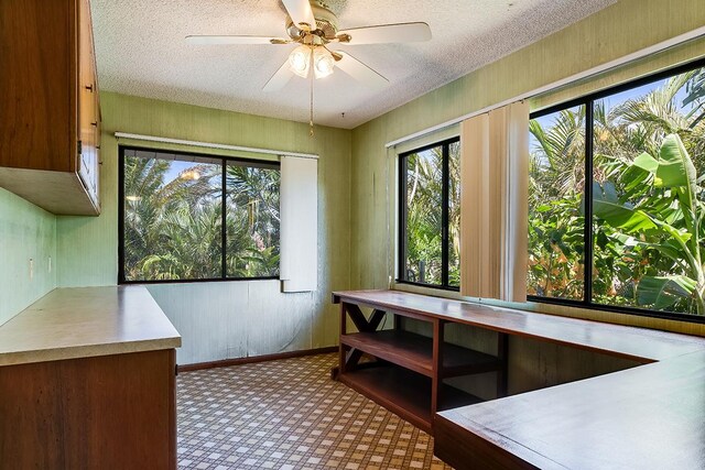 68-3753 Piki Pl, Waikoloa, HI 96738 - unfurnished dining area with healthy amount of natural light, a textured ceiling, tile patterned floors, a ceiling fan, and baseboards