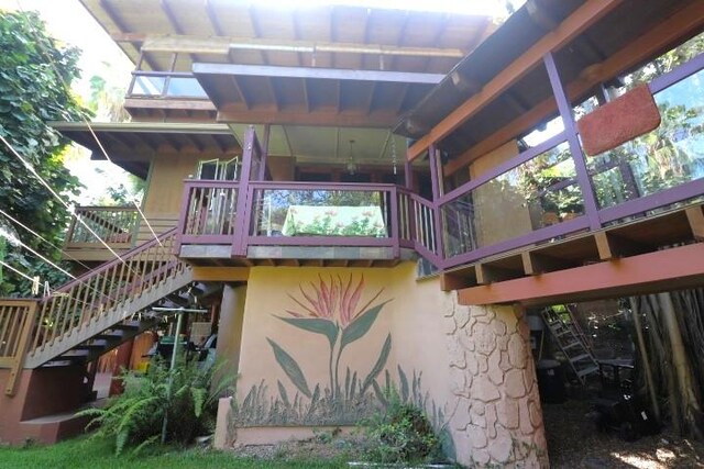 82-6286 Puuhonua Rd, Captain Cook, HI 96704 - rear view of house with stairs and stucco siding