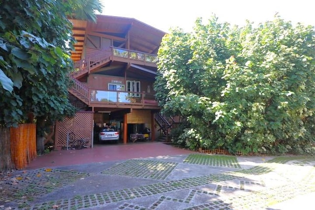 82-6286 Puuhonua Rd, Captain Cook, HI 96704 - rear view of house featuring a carport, stairway, and driveway