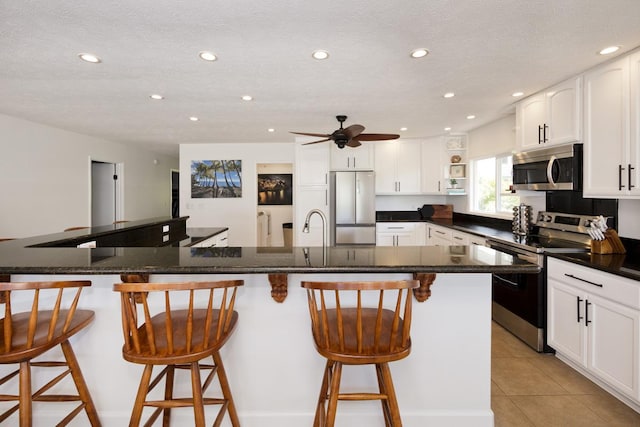 15-112 Kuna St, Pahoa, HI 96778 - kitchen featuring appliances with stainless steel finishes, recessed lighting, open shelves, ceiling fan, and white cabinetry