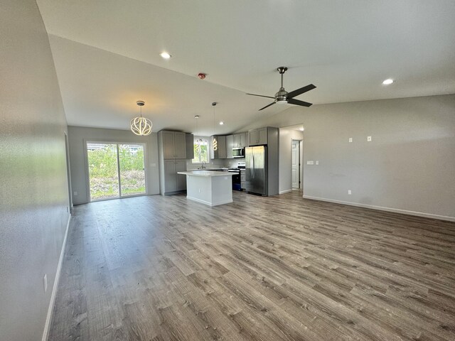 16-2142 Kuhio Dr, Pahoa, HI 96778 - unfurnished living room featuring lofted ceiling, wood finished floors, recessed lighting, a ceiling fan, and a chandelier