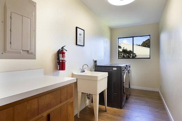 99-7715 Kalehua Pl, Volcano, HI 96778 - washroom with electric panel, separate washer and dryer, light wood-style flooring, and baseboards