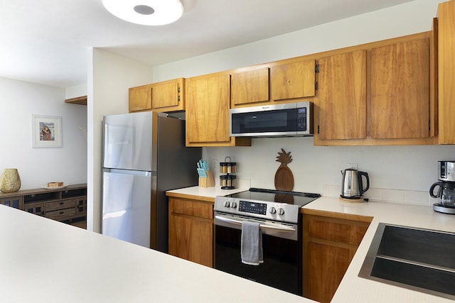 99-7715 Kalehua Pl, Volcano, HI 96778 - kitchen with appliances with stainless steel finishes, light countertops, and brown cabinets