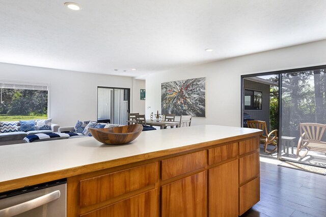 99-7715 Kalehua Pl, Volcano, HI 96778 - kitchen featuring open floor plan, light countertops, dark wood-type flooring, recessed lighting, and brown cabinetry