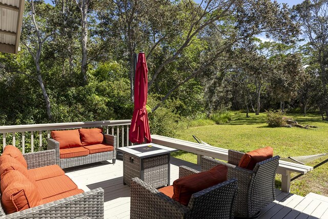 99-7715 Kalehua Pl, Volcano, HI 96778 - wooden deck with a lawn, outdoor lounge area, and view of wooded area