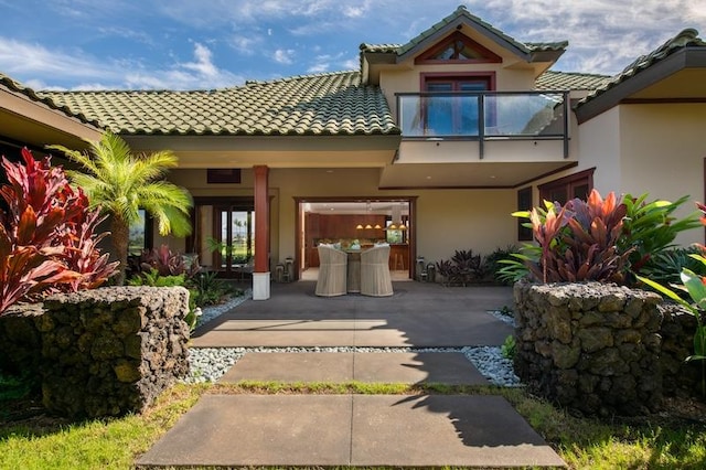 68-1051 Honokaope Way, Kamuela, HI 96743 - doorway to property with stucco siding, a patio area, a balcony, and a tile roof