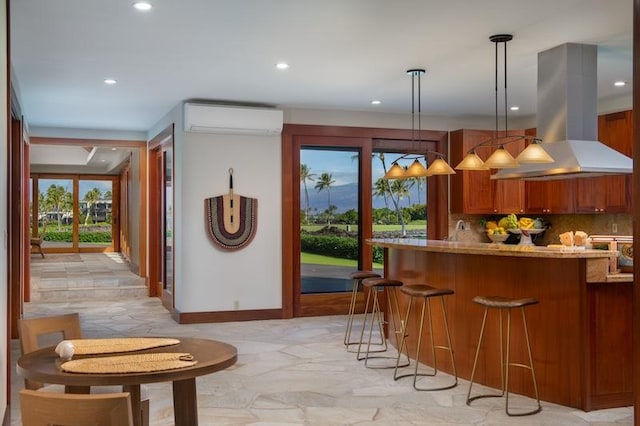 68-1051 Honokaope Way, Kamuela, HI 96743 - kitchen with island range hood, a wall unit AC, brown cabinetry, recessed lighting, and baseboards