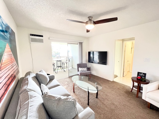 74-5618 Palani Rd Unit M6, Kailua-Kona, HI 96740 - living area featuring carpet, a wall mounted air conditioner, ceiling fan, and a textured ceiling