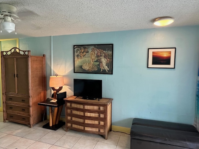 75-5776 Kuakini Hwy Unit 339, Kailua-Kona, HI 96740 - living area with a textured ceiling, tile patterned flooring, baseboards, and ceiling fan