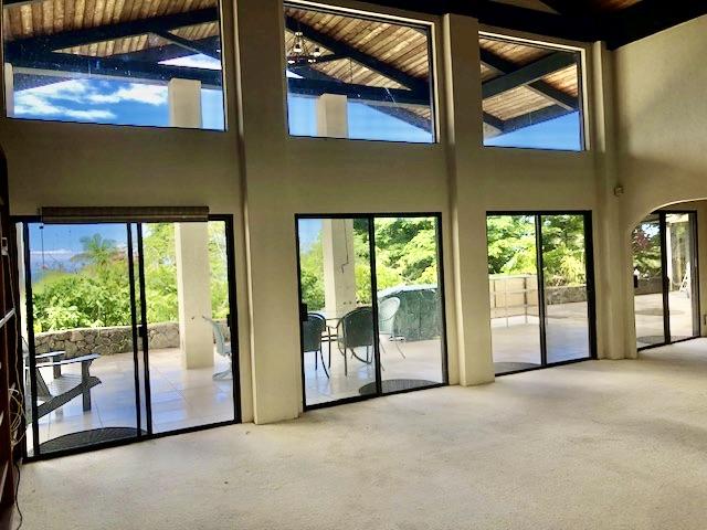 73-4820 Anini St, Kailua-Kona, HI 96740 - doorway to outside with plenty of natural light, high vaulted ceiling, carpet floors, and wooden ceiling with exposed beams