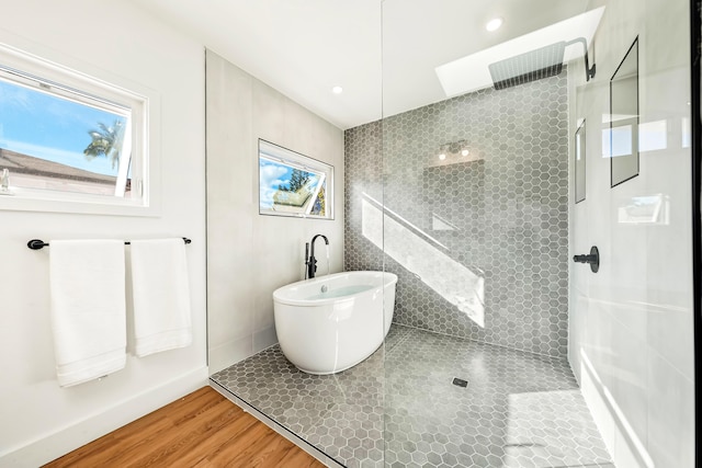 5111 Weke Rd, Hanalei, HI 96714 - bathroom featuring plenty of natural light, a soaking tub, walk in shower, and wood finished floors