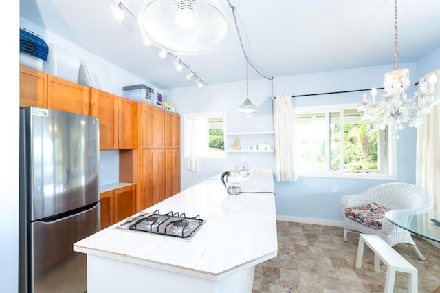 27-624 Kahalii Pl, Pepeekeo, HI 96781 - kitchen featuring freestanding refrigerator, light countertops, gas cooktop, pendant lighting, and baseboards