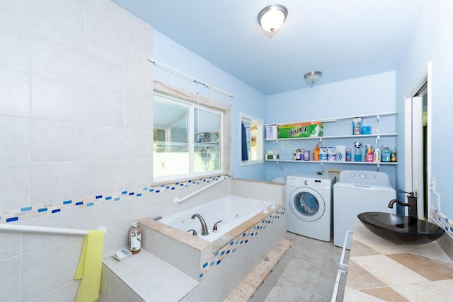 27-624 Kahalii Pl, Pepeekeo, HI 96781 - bathroom featuring a bath, a sink, and separate washer and dryer