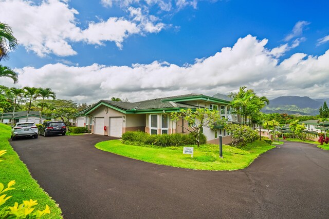 4141 Lei O Papa Rd Unit 50, Princeville, HI 96722 - view of front of home featuring stucco siding, a garage, asphalt driveway, and a mountain view