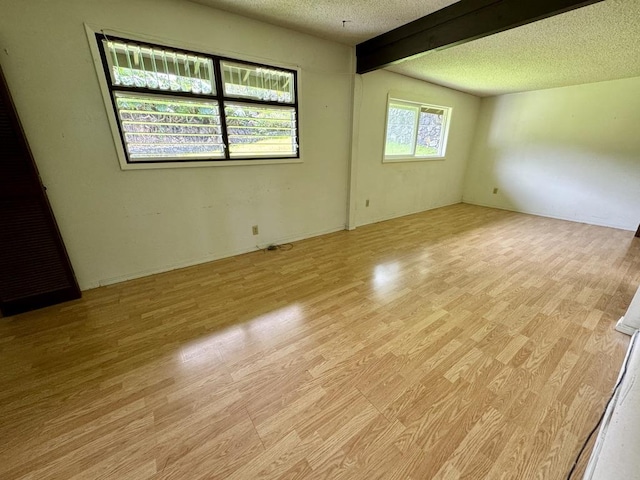 74-5075 Kau Pl, Kailua-Kona, HI 96740 - unfurnished room featuring light wood-style flooring, beam ceiling, and a textured ceiling