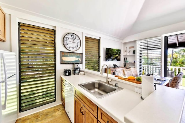 2253 Poipu Rd Unit 154, Koloa, HI 96756 - kitchen featuring a sink, white appliances, vaulted ceiling, light countertops, and brown cabinets