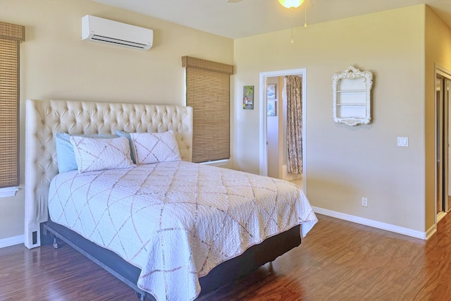76-149 Kamehamalu St, Kailua-Kona, HI 96740 - bedroom with a wall unit AC, baseboards, and wood finished floors