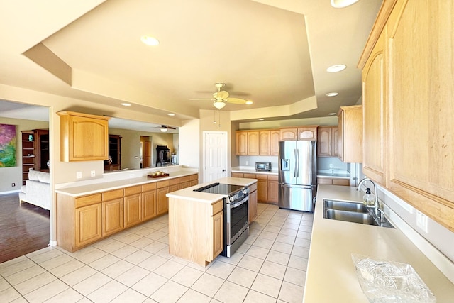 76-149 Kamehamalu St, Kailua-Kona, HI 96740 - kitchen with stainless steel appliances, light brown cabinets, a tray ceiling, a sink, and recessed lighting