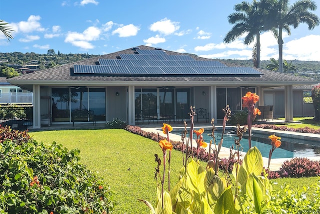 76-149 Kamehamalu St, Kailua-Kona, HI 96740 - back of property featuring a yard, roof mounted solar panels, an outdoor pool, and a patio area