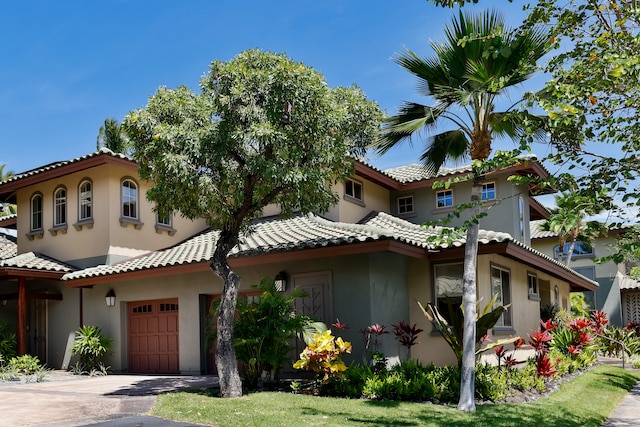 68-1125 Kaniku Dr Unit 706, Kamuela, HI 96743 - mediterranean / spanish home featuring stucco siding, driveway, and a tile roof