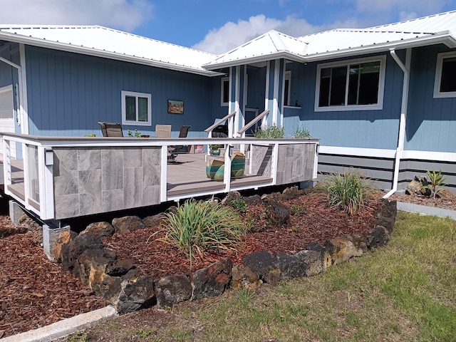 94-1770 Kaulua St, Naalehu, HI 96772 - view of front of house with a wooden deck and metal roof