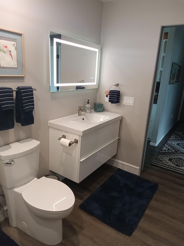94-1770 Kaulua St, Naalehu, HI 96772 - bathroom with wood finished floors, vanity, toilet, and baseboards
