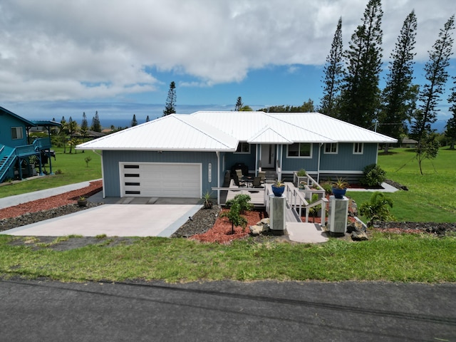 94-1770 Kaulua St, Naalehu, HI 96772 - view of front of property featuring metal roof, an attached garage, a front yard, and driveway