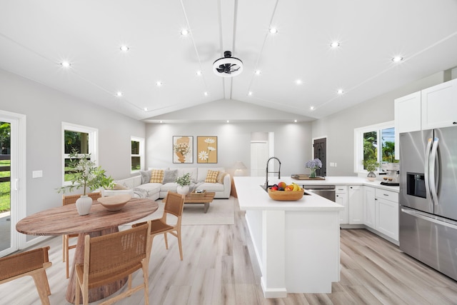 850 Kamalu Rd, Kapaa, HI 96746 - kitchen with stainless steel appliances, lofted ceiling, light wood-style flooring, light countertops, and open floor plan