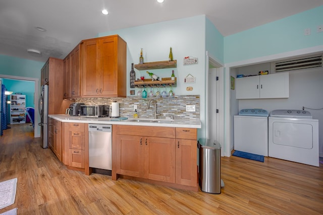 83-1008 Kahula Pl, Captain Cook, HI 96704 - kitchen with a sink, appliances with stainless steel finishes, washer and dryer, light wood-type flooring, and light countertops