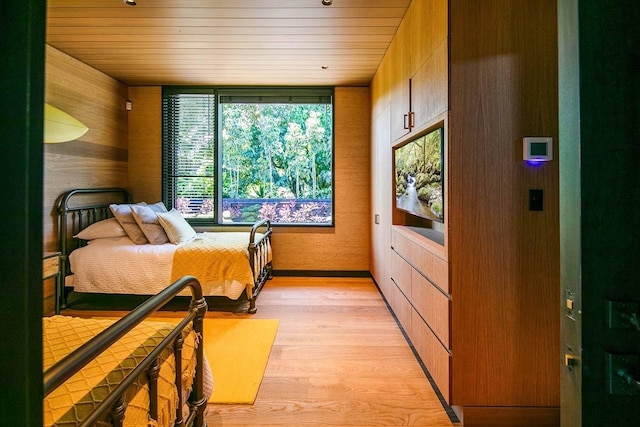 5515 Weke Rd, Hanalei, HI 96714 - bedroom with wood walls, wooden ceiling, and light wood-style flooring