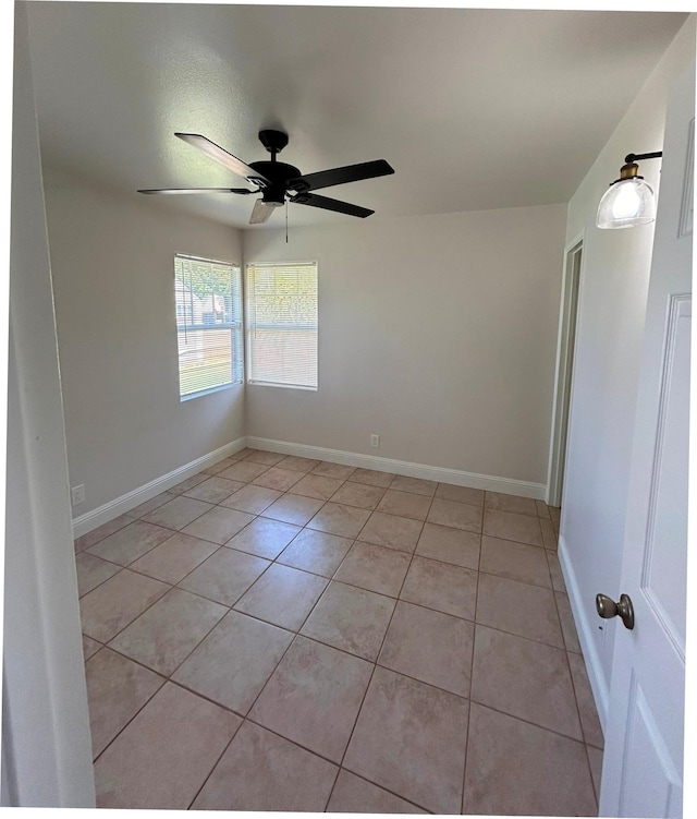 723 Laulea St, Eleele, HI 96705 - empty room featuring light tile patterned floors, ceiling fan, and baseboards