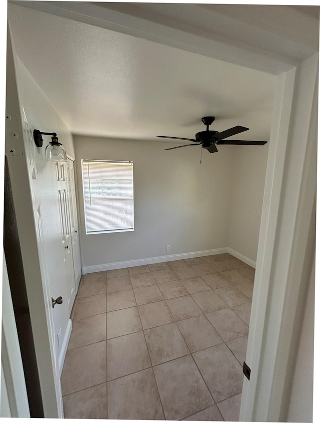 723 Laulea St, Eleele, HI 96705 - unfurnished room featuring light tile patterned flooring, a ceiling fan, and baseboards