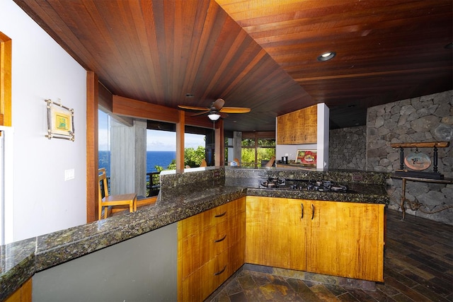 36-2850 Hawaii Belt Rd, Ookala, HI 96774 - kitchen with wooden ceiling, a ceiling fan, dark stone counters, brown cabinets, and recessed lighting