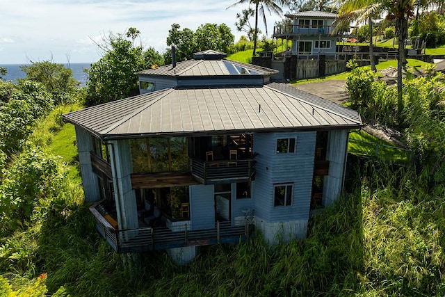 36-2850 Hawaii Belt Rd, Ookala, HI 96774 - view of front of house featuring a standing seam roof, a balcony, metal roof, and a water view
