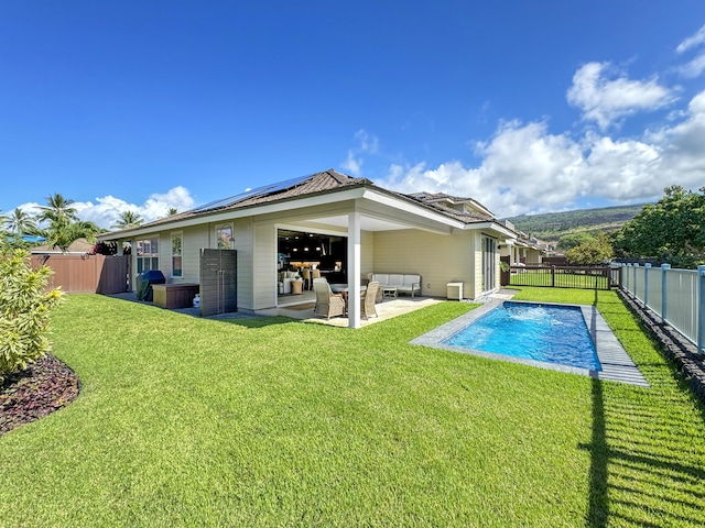 78-122 Holuakai St, Kailua-Kona, HI 96740 - back of property featuring solar panels, outdoor lounge area, and a patio