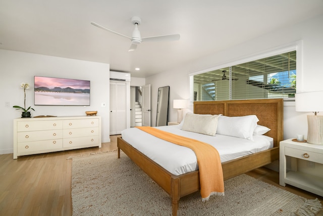 5108 Opelu St, Hanalei, HI 96714 - bedroom with a wall unit AC, light wood-type flooring, a ceiling fan, and recessed lighting