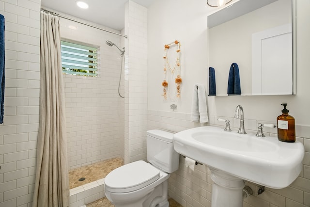 5108 Opelu St, Hanalei, HI 96714 - bathroom with toilet, tiled shower, a sink, tile walls, and wainscoting
