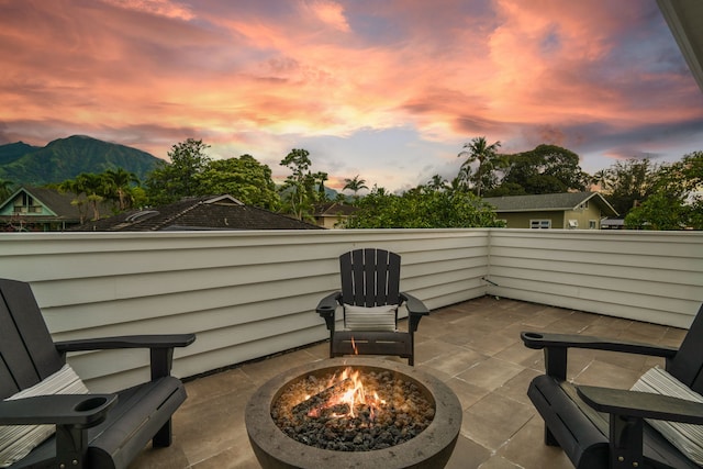 5108 Opelu St, Hanalei, HI 96714 - patio terrace at dusk featuring a fire pit, a patio area, and a mountain view