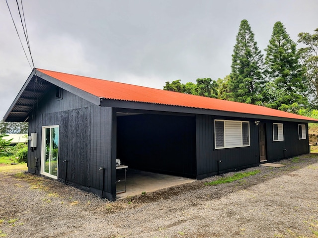 94-6451 Kamaoa Rd, Naalehu, HI 96772 - view of side of home featuring metal roof