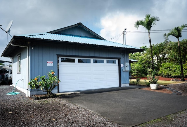 15-1688 9th Ave, Keaau, HI 96749 - view of side of home with asphalt driveway, metal roof, and a garage