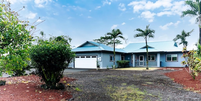 15-1688 9th Ave, Keaau, HI 96749 - single story home with an attached garage, a porch, driveway, and metal roof