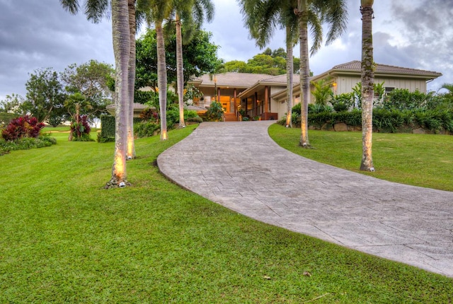 3925 Kamehameha Rd, Princeville, HI 96722 - view of front facade featuring curved driveway and a front yard