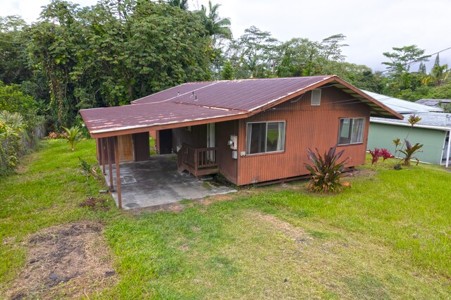 14-3435 Nanawale Blvd, Pahoa, HI 96778 - view of front of home with a carport, a front yard, a patio, and metal roof